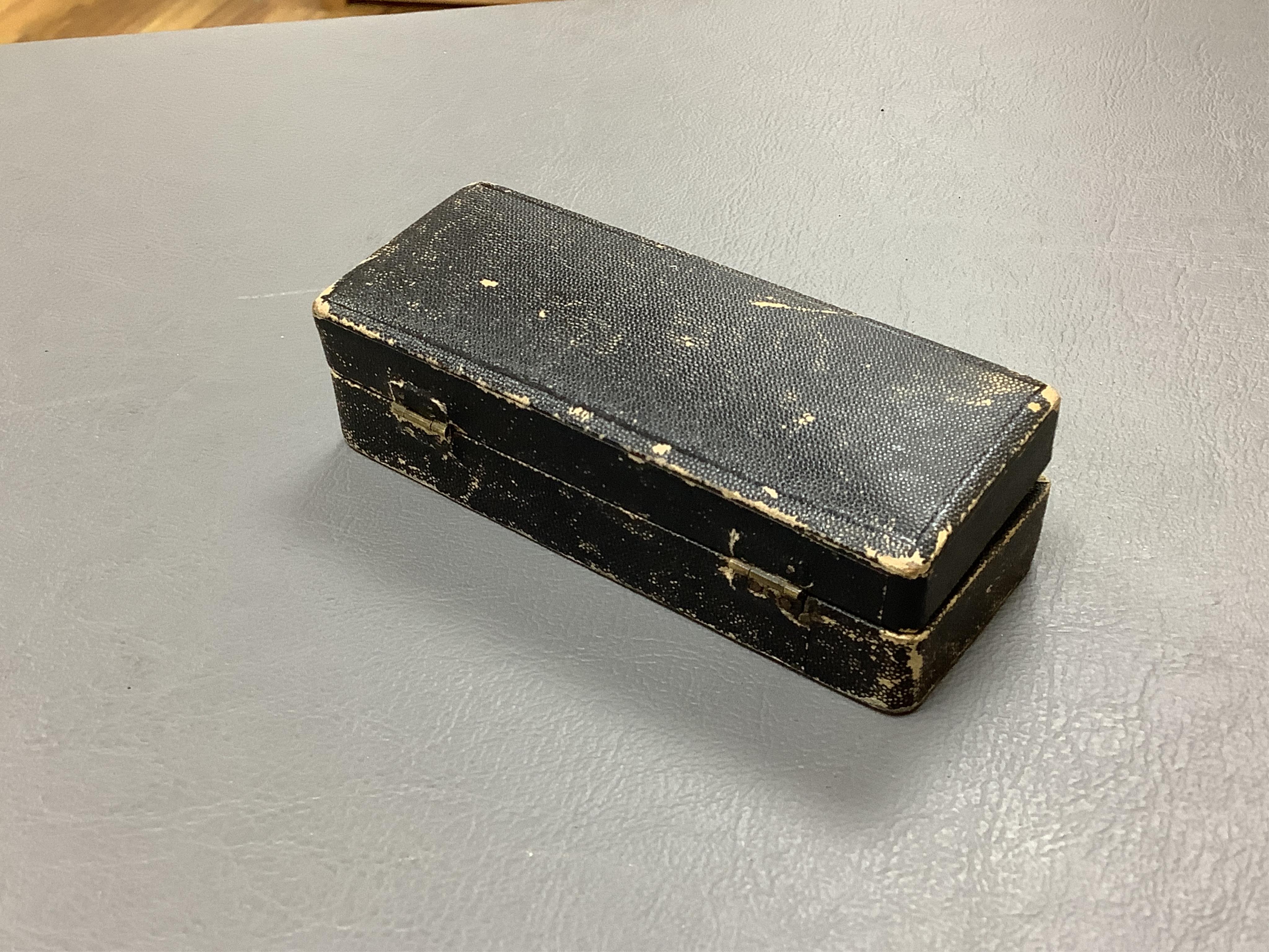 A late 19th century cased group of three prosthetic glass eyes